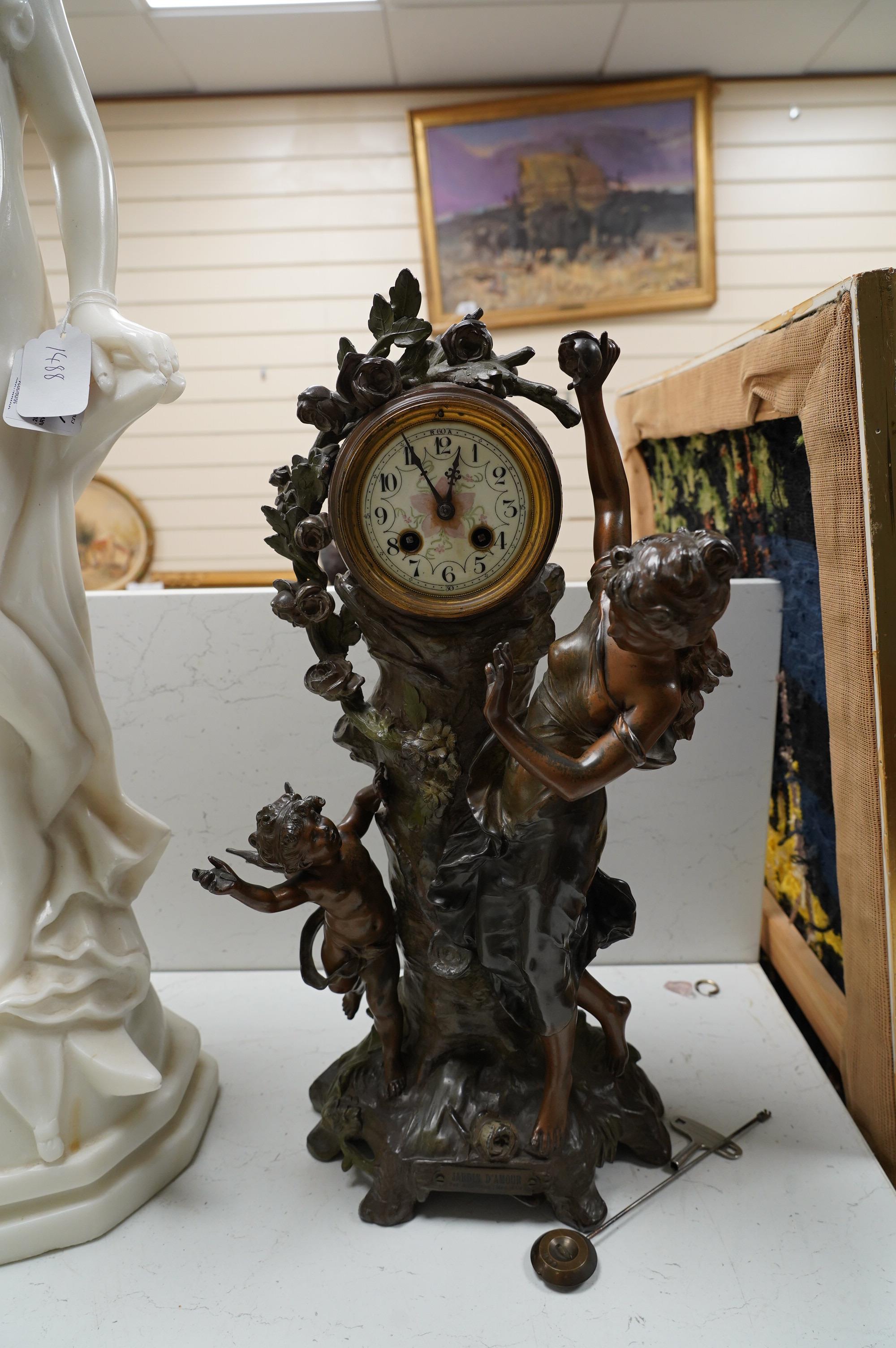 A French Art Nouveau spelter patinated figural table clock, ‘Jardin D’Amour’, with a late 19th century movement striking on a bell, height 53cm. Condition - good